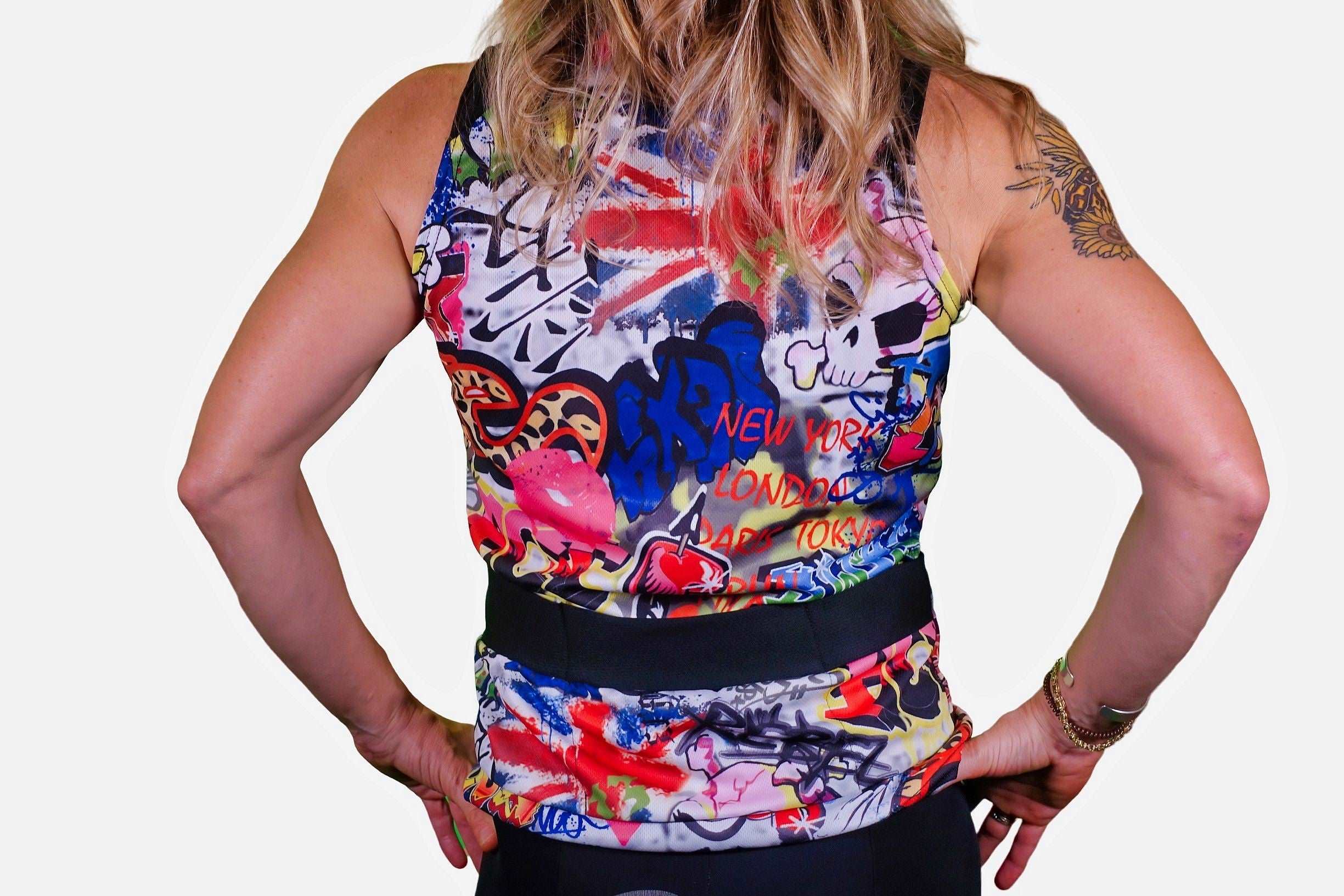 Graffiti print top with vibrant colors and city names, flattering drop waist style.